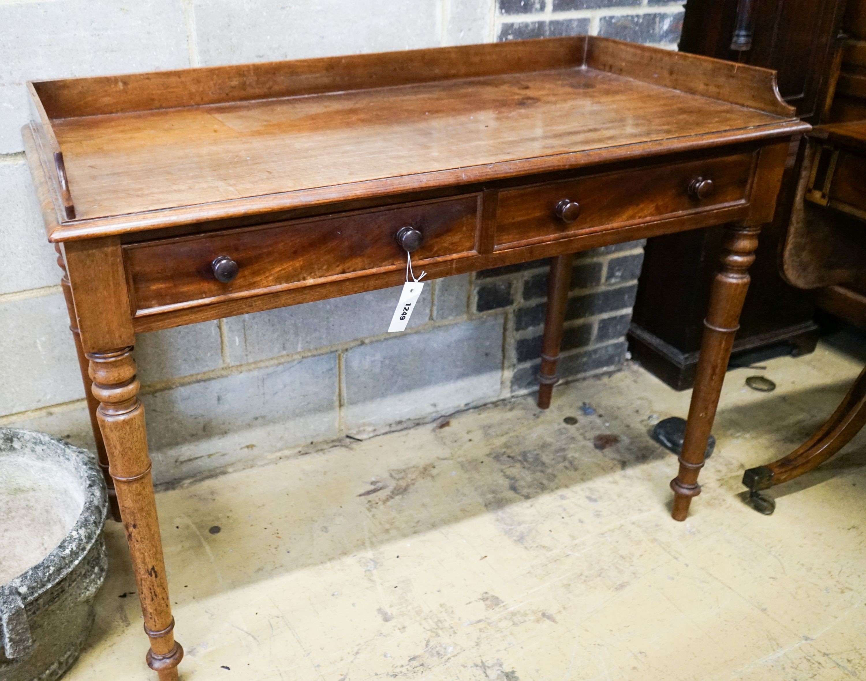 A Victorian mahogany two drawer side table stamped 